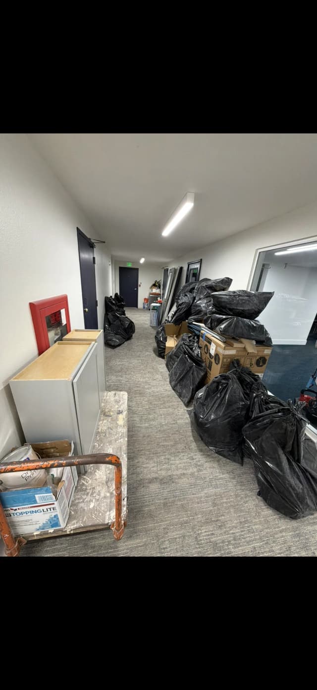 Apartment hallway lined with bags and cleanup material before removal