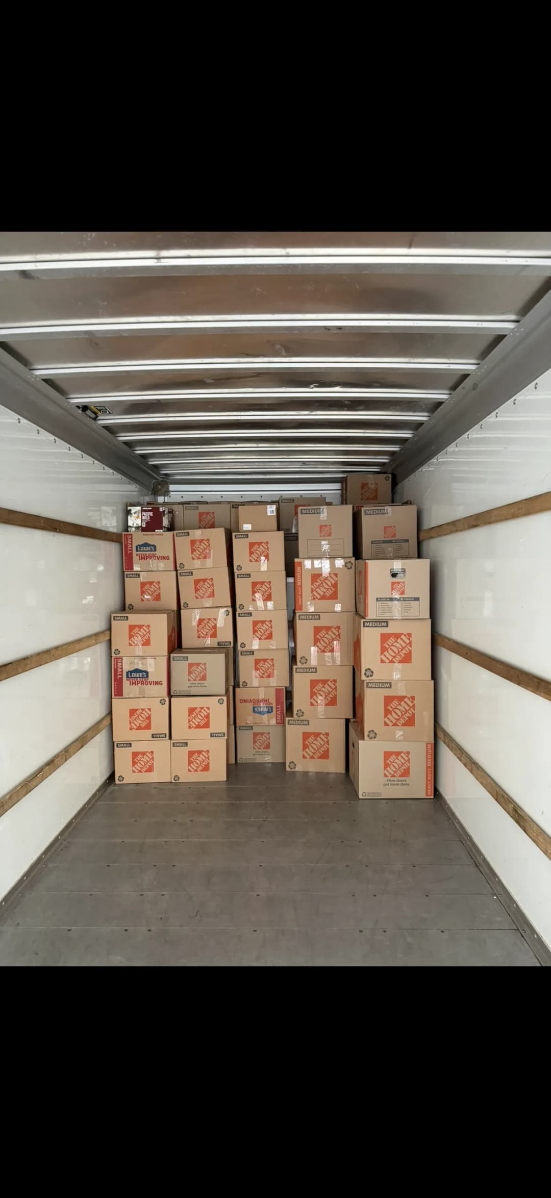 Moving truck staged with packed household boxes